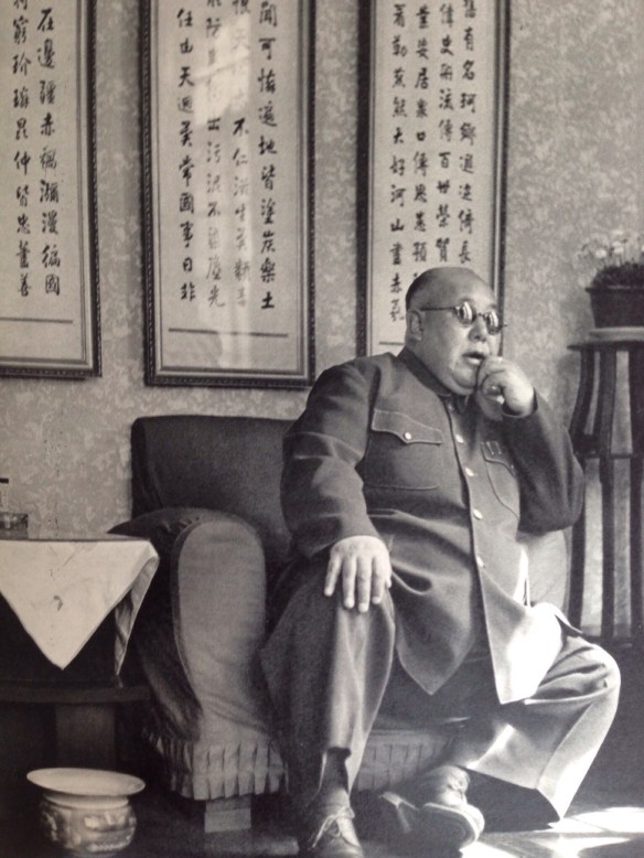 General Ma Hung-kwei came to Nanking, Kuomintang capital, every year to meet Marshal Chiang K'ai-shek. The first syllable of his name, Ma, means horse, a very common name designation among Chinese Moslems. Behind him, carefully written, are some old ryhmed precepts: "A good general should occupy a splendid place in history. He should be praised during a hundred generations. He should be full of care for his men and also for his people." General Ma was the big war lord of Northwest China. His secretaries were dressed as hospital nurses. He adored ice cream and always had bucketfuls handy, and offered to his guests. Shortly after this photograph was taken, General Ma was abandoned by his troops.
